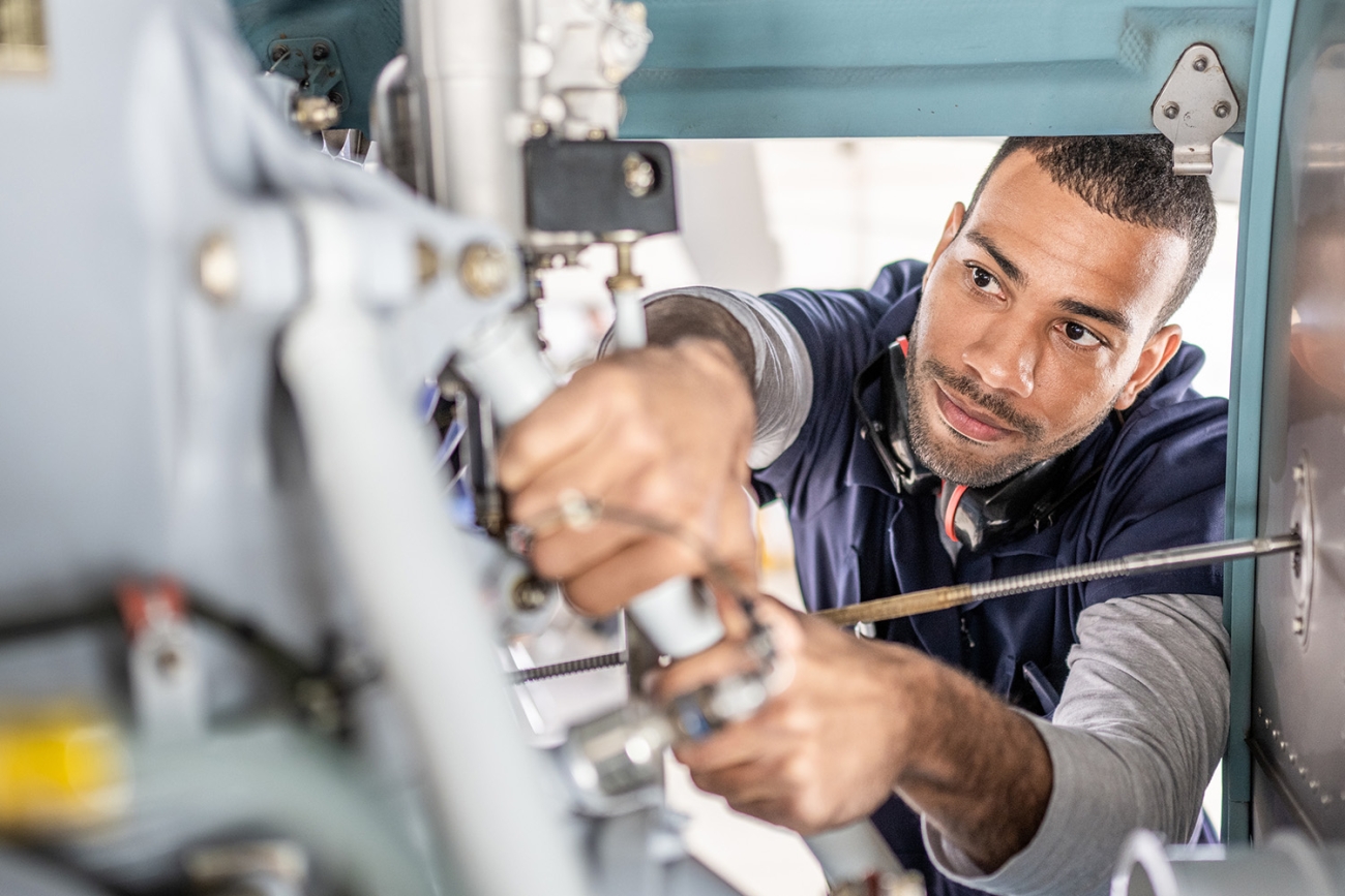 mechanic working on machine interior